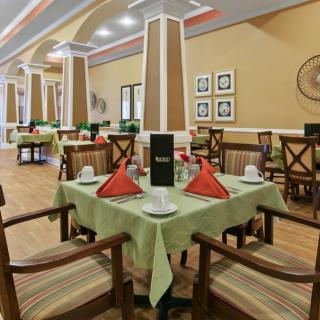 A neatly arranged dining area with elegantly set tables in a restaurant.