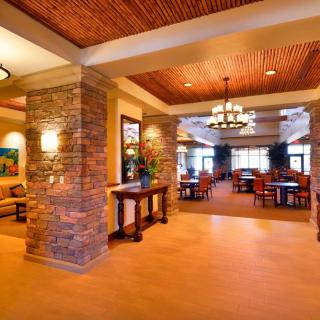 Spacious hotel lobby with elegant stone pillars and a warm, inviting atmosphere.