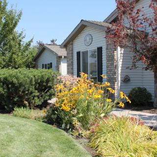 A beautiful residential garden featuring vibrant flowers and well-maintained landscaping.
