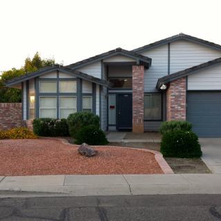 A suburban house with a well-maintained front yard and modern architecture.