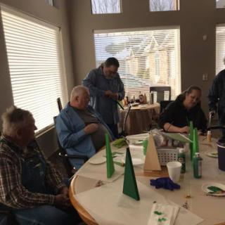 A group of individuals enjoying a social gathering around a table with decorations.