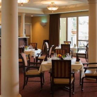 An elegant restaurant dining area with neatly arranged tables and chairs.