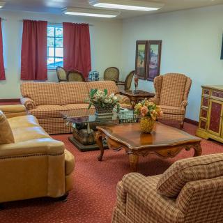 A cozy living room with sofas, chairs, and a coffee table.