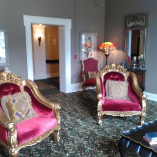 A luxurious living room featuring vintage armchairs and elegant decor.