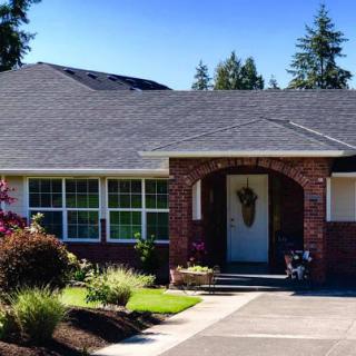 A charming residential home with well-maintained landscaping and a welcoming entrance.