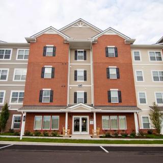 A multi-story residential apartment building with a brick facade.