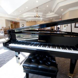 A grand piano in an elegant and spacious living room.