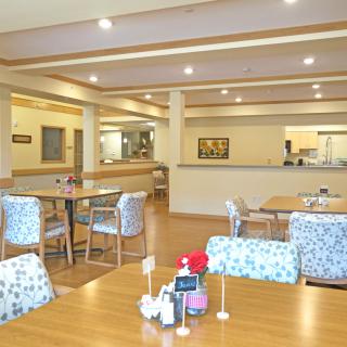 A cozy, well-lit restaurant dining area with tables and chairs arranged neatly.