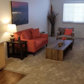 A cozy living room with a red sofa and wooden coffee table.