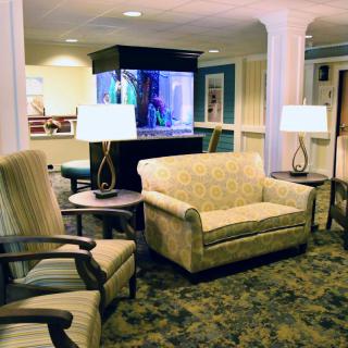 A cozy lobby area with seating and a fish tank.