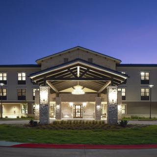 A hotel entrance illuminated at night.