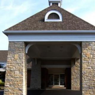 A building entrance with a stone facade and symmetrical design.