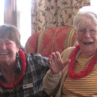 Two people smiling and enjoying time together indoors.