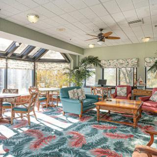 A cozy lounge area adorned with comfortable seating, vibrant decor, and abundant natural light.