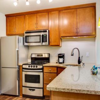 Modern kitchen with stainless steel appliances and wooden cabinets.