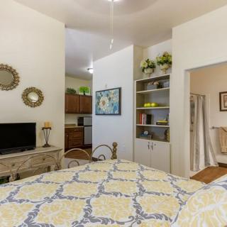 Cozy living room with a stylish decor featuring a television, bookshelf, and decorative elements.