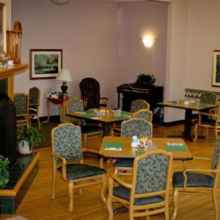 A cozy indoor dining area with neatly arranged tables and chairs, adorned with decor.