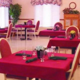 A cozy dining area with red tablecloths and neatly arranged tables in a restaurant.