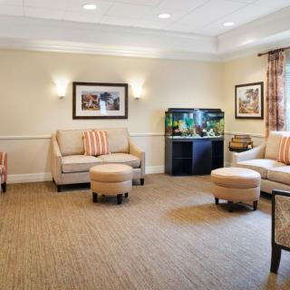 A cozy living room with comfortable seating and an aquarium.