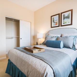 A cozy bedroom with stylish decor, featuring a neatly made bed and a soft color palette.