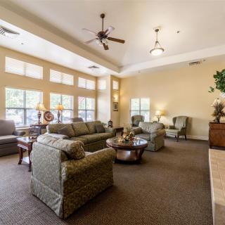 A spacious and elegant living room with comfortable seating and large windows.