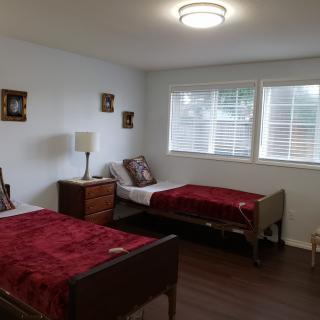 A cozy bedroom with two single beds and elegant decor.