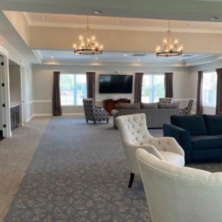 Spacious living room with comfortable seating and elegant chandeliers.