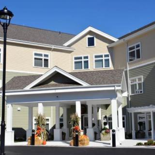 A residential building with a covered entrance and decorative planters.