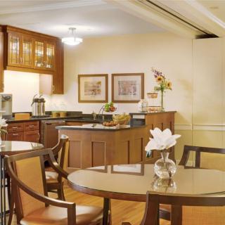 A modern kitchen and dining area with wooden furniture and elegant decor.