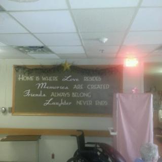 A chalkboard displaying messages of care in a hospital setting.