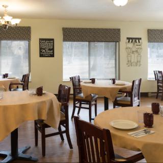 A cozy dining area featuring neatly arranged tables and chairs, perfect for casual meals.