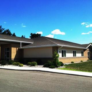 A suburban residential house under a clear blue sky.