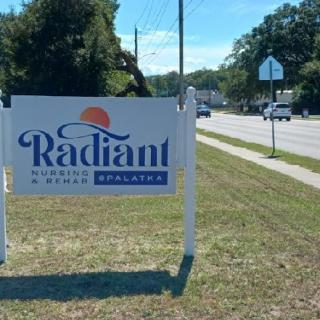 A sign for Radiant Heating & Cooling Solutions located along a road.