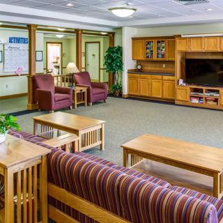 A cozy living room with comfortable seating and a television cabinet.