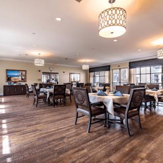 A spacious dining area with elegantly set tables and comfortable seating.