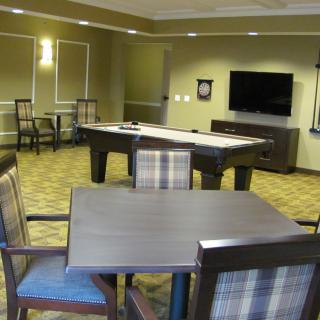 A cozy game room featuring a pool table and a flat-screen TV.