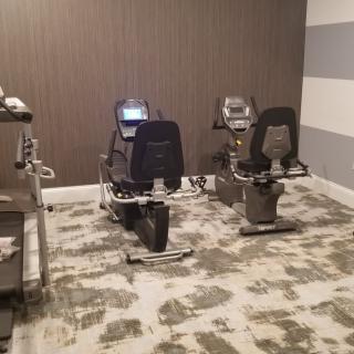 A small gym room with exercise bikes and other fitness equipment.