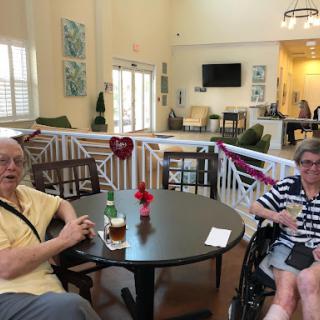 Two elderly individuals enjoying a moment in a warm and inviting communal space.