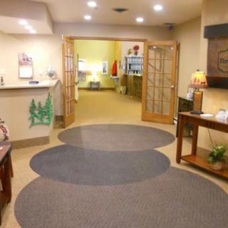 A welcoming office reception area with warm lighting and comfortable furnishings.