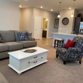 A cozy open-concept living room with comfortable seating and modern decor.