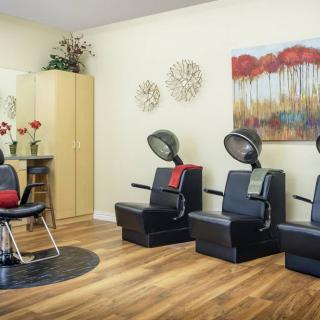 A modern salon interior featuring hair drying chairs and stylish decor.