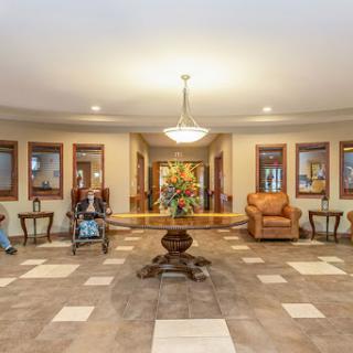 A spacious and welcoming lobby featuring comfortable seating, elegant decor, and natural lighting.