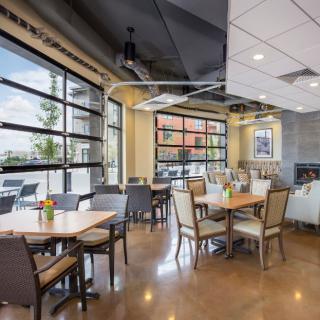 A modern restaurant interior with large windows and well-arranged dining tables.