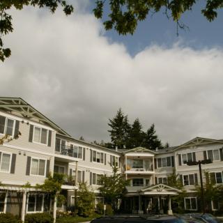 A residential building with classic architecture on a cloudy day.