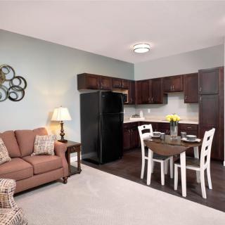 A cozy open-plan living space with a kitchen, dining area, and seating.