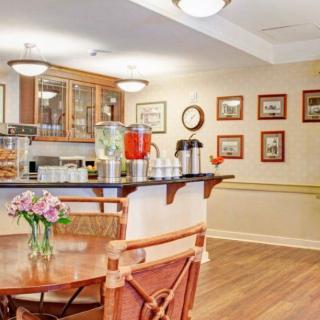 A cozy cafe-style area with a refreshment station and wooden seating.