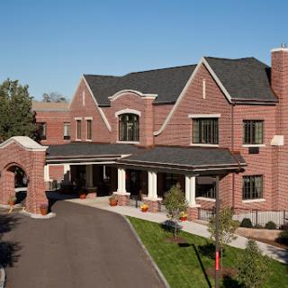 A charming brick building with a welcoming entrance and landscaped surroundings.