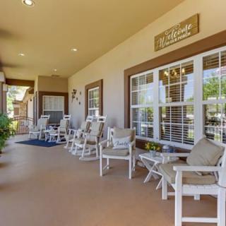 A cozy outdoor patio with chairs and decorative elements, offering a relaxing space outside a building.