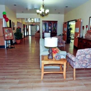 A spacious lobby area featuring comfortable seating, elegant lighting, and tasteful decorations.