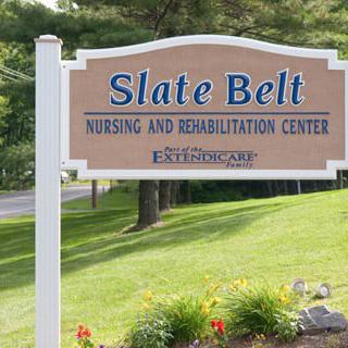 A sign for Slate Belt Nursing and Rehabilitation Center located outdoors.